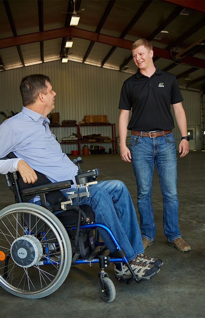 Producer in a wheelchair talking to an ADM rep