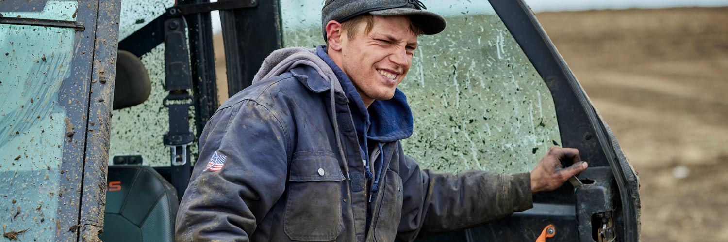 man exiting a tractor