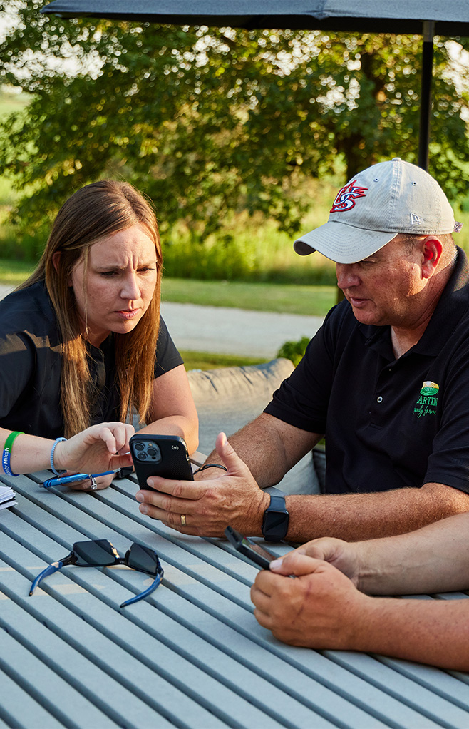 ADM rep and producer looking at a phone
