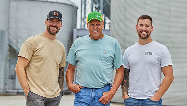 three men smiling at the camera